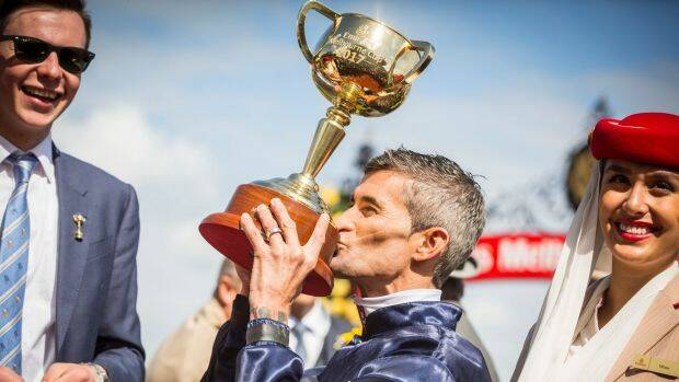 You little beauty: Corey Brown gives the Melbourne Cup a kiss after his win on Rekindling on Tuesday. Manning Valley Race Club hopes the Wingham-born Brown will be available to attend its official launch on January 4.