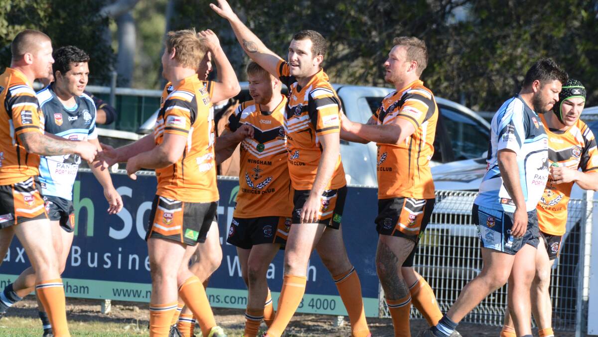 Wingham players congratulate second rower Tim Watson after he scored their first try in the minor semi-final against Port City.