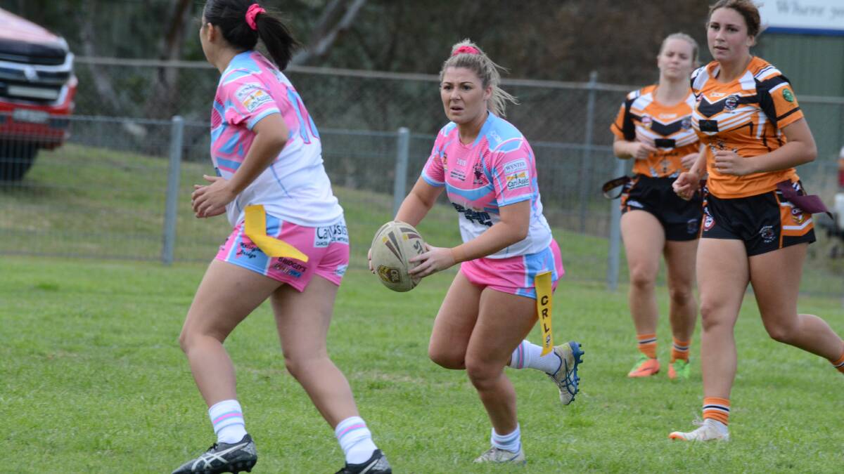 Taree City's Sarah O'Connor looks to position a support player during the league tag clash against Wingham. Sarah represented North Coast in the Country Women's Rugby League Championships this year.