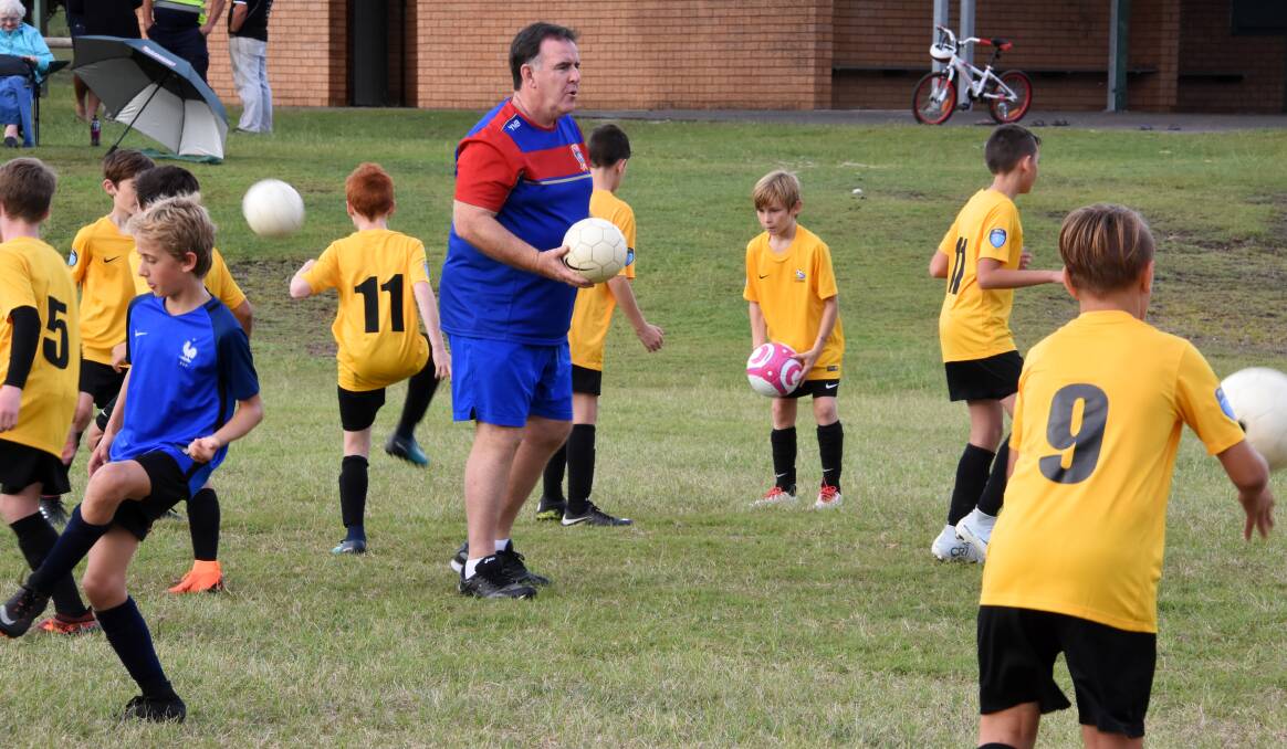 Newcastle chief executive Lawrie McKinna conducting a coaching clinic at Taree this week. He confirmed the Jets will return to this area during the A-League off-season.