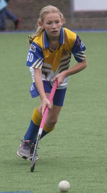 Lily on the ball for Tigers under 11s.