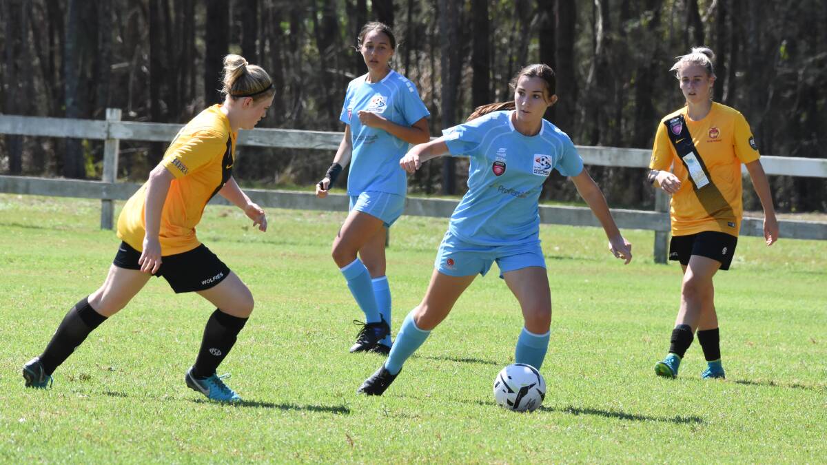 Football Mid North Coast's Ruby Grass tries to work through the South Wallsend defence during the opening women's premier league game at Taree. FMNC meets New Lambton on Sunday at Taree. 