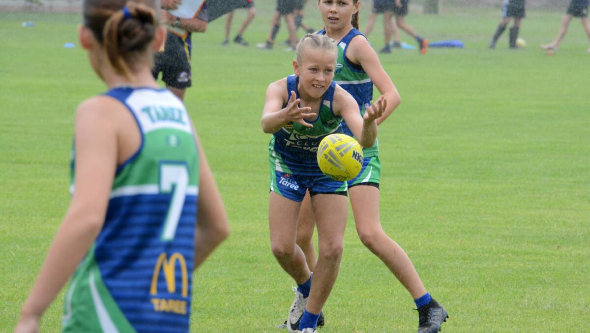 Georgie O'Connor from Taree Flames under 12s whips out a pass during a game in the Northern Eagles championships at Tuncurry.