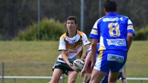 Group Three halfback Nav Willett offloads in the clash against Group Four. Group Three plays in the Country final against NRL Victoria on Saturday at Wyong.