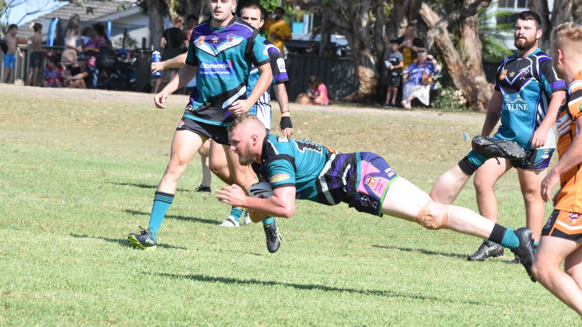 Taree City's Rob Mason crashes over for a try during a pre-season game against Wingham.