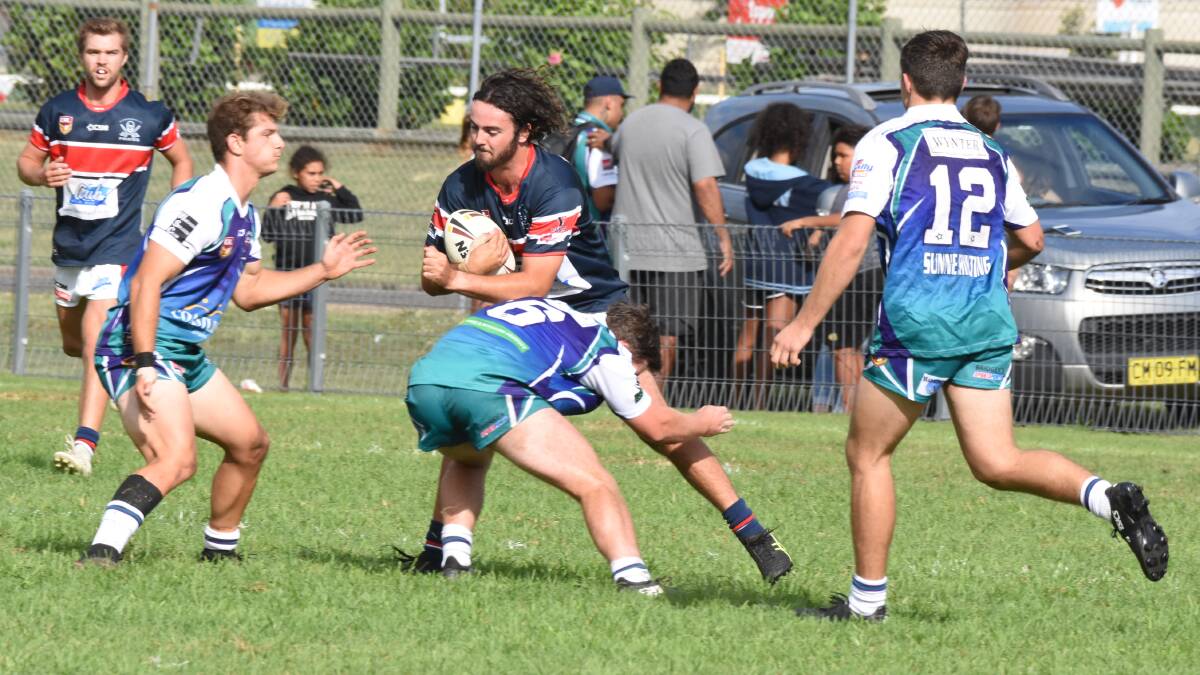 Old Bar centre Joel Minihan is rounded up by Taree City defenders.