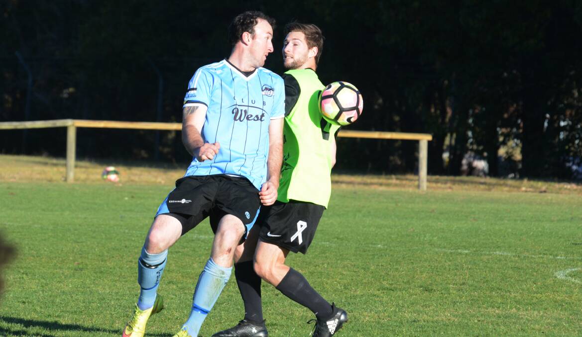 Face off: Taree's Ricky Campbell eyes off a Wallis Lake opponent during the Football Mid North Coast Premier League elimination semi-final.