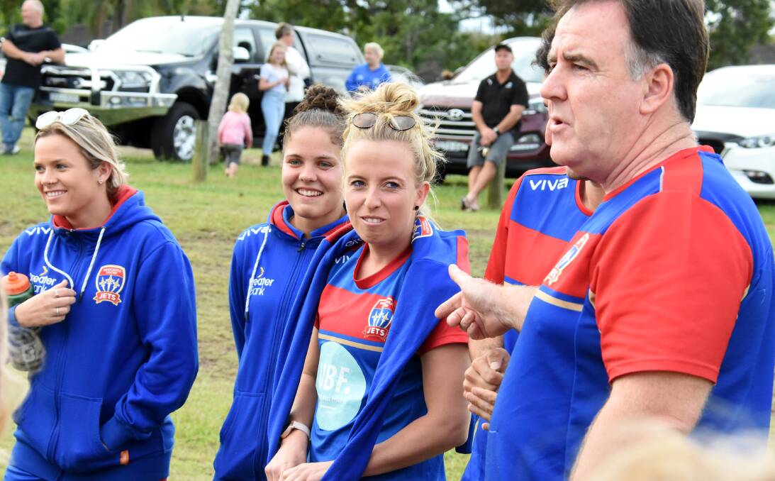 Newcastle Jets chief executive Laurie McKinna with W-League stars Hannah Brewer, Cassidy Davis and Sophie Nenadovic at a coaching clinic in Taree this year. The Jets will play a trial game in Taree on Sunday against a Football Mid North Coast Selection.