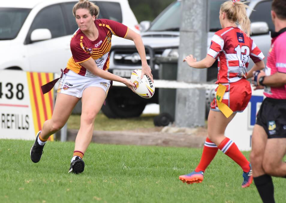 Old Bar's Talisa Eason offloads playing for Group Three in the representative league tag clash against Group Two at Wingham.