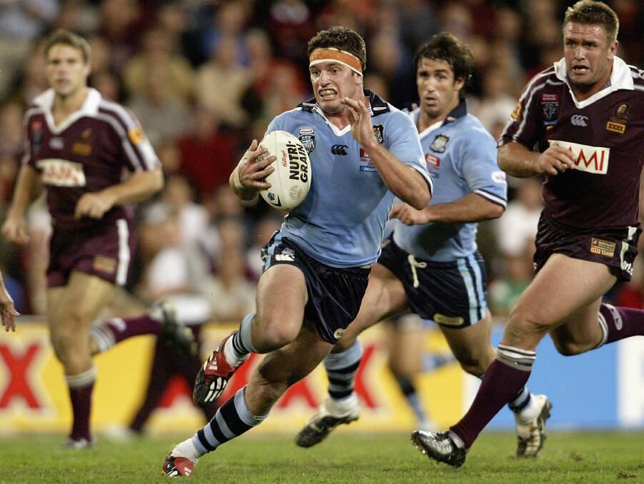 Danny Buderus makes a break for NSW during the 2005 State of Origin series. Andrew Johns is looming up in support. Buderus captained NSW to victory in the series.
