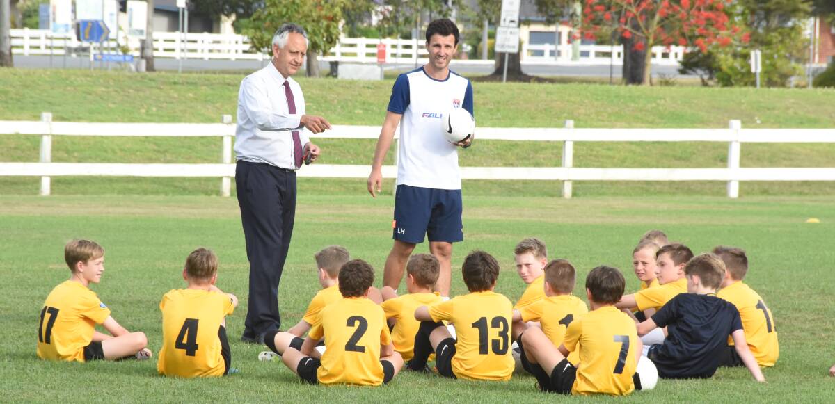 Newcastle Jets youth coach  Labinot Halit speaks to the Football Mid North Coast National Premier League under 13s during a training session at Taree.