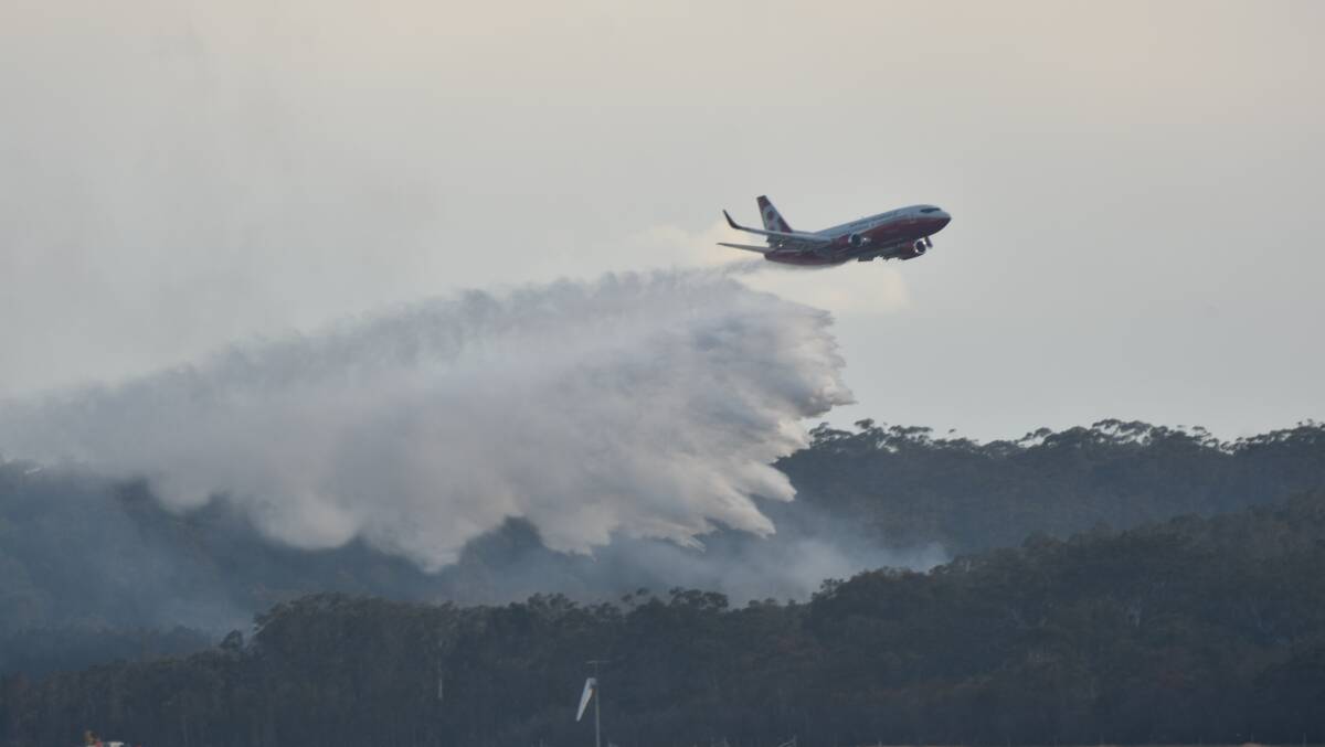 Water bombed: The 737 large air tanker Marie Bashir makes her maiden water drop on the Lindfield Park Road, Port Macquarie, bushfire in August, 2019. Photo: Rob Dougherty.