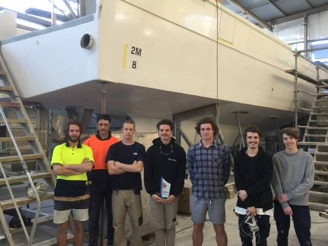 Steber apprentices pictured with Investigator II in the background: Beau Gilbert, Ray Haley, Ben Shannon, Beau Paff (holding the 2019 Australian Marine Industry Export Award), Jordan Smith, Callum Lewis and Levi Steber. Absent when photo taken - Chris Ellis, Jack Wighton. 