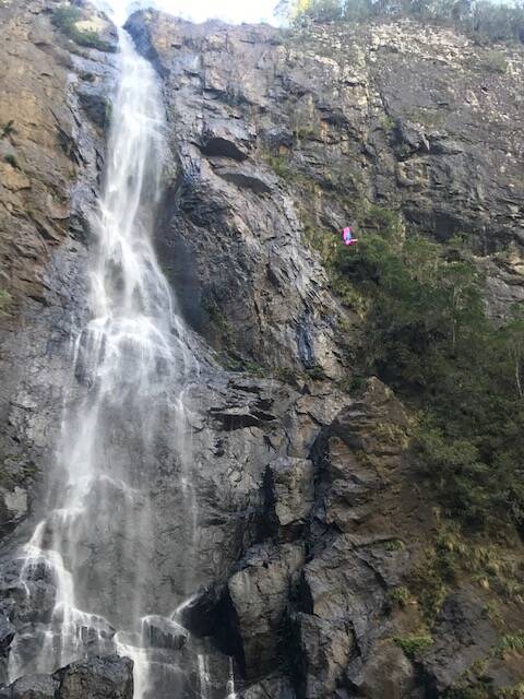 BASE jumper (to the right with a pink chute) caught mid-flight at Ellenborough Falls on Sunday, May 19. Quenten Jackson took this photograph.
