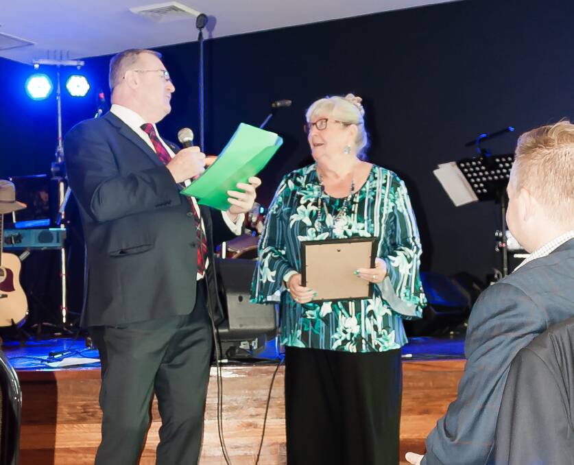 Anna Sinclair receives a seniors local achievement award from Myall Lakes MP Stephen Bromhead.