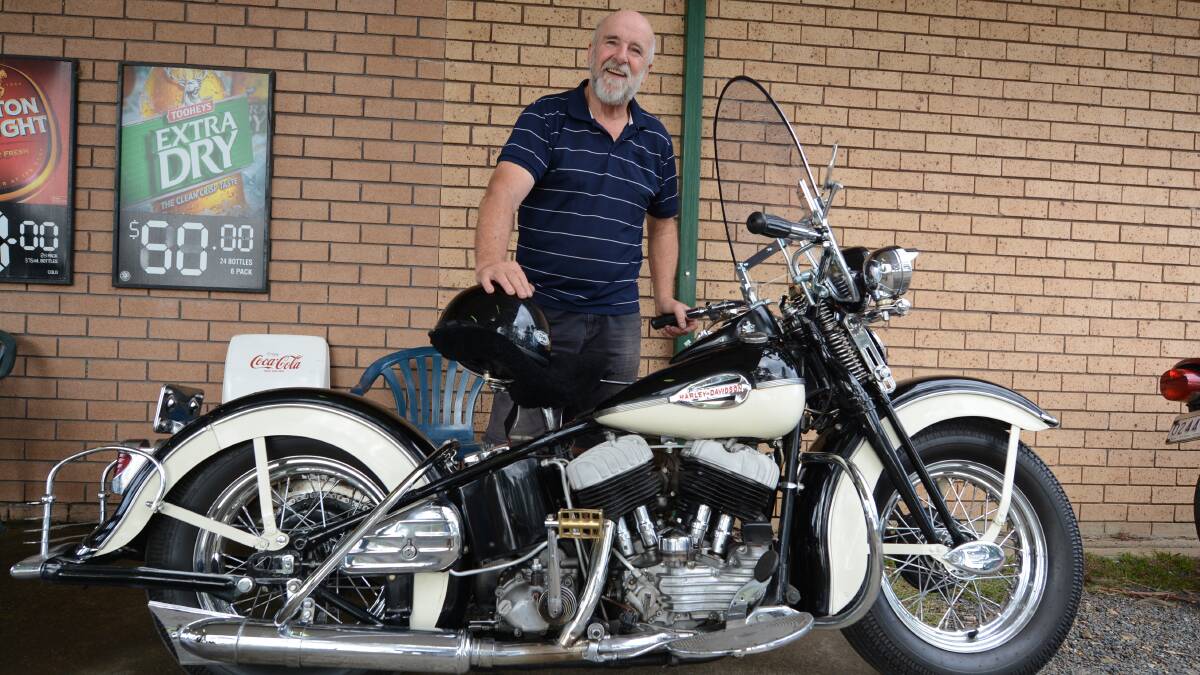 A proud owner and his classic motorcycle.