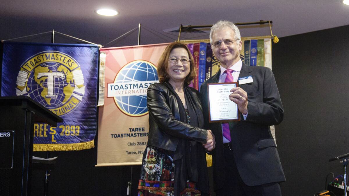 Taree Toastmasters president Michael Hollingworth accepts a 50th anniversary award from Toastmasters District 90 Director Julia Childs.