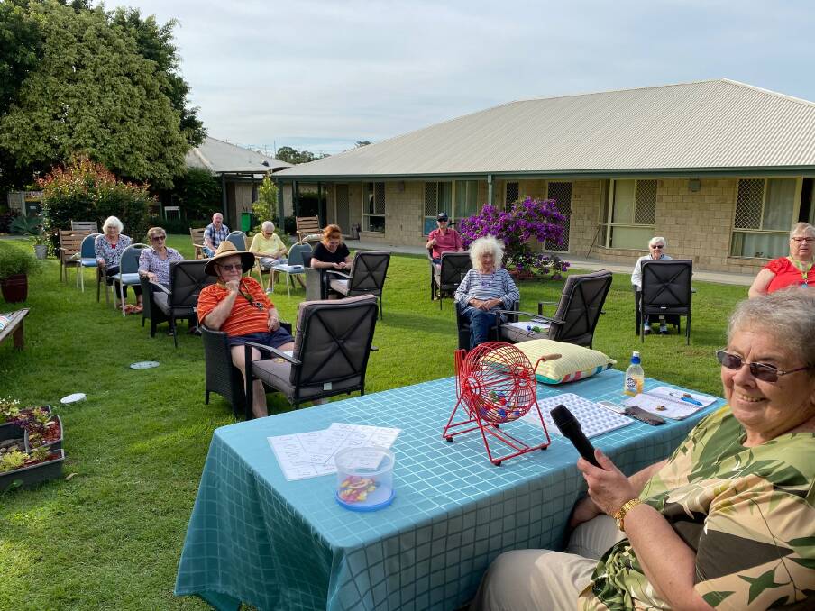  Dot Stuart (second back row on the left) and Ingenia Gardens Taree residents playing bingo.