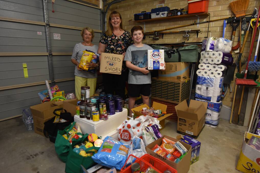 Jan Wallace, Janelle and Ethan with some of the goods to be delivered to the community of Trundle.
