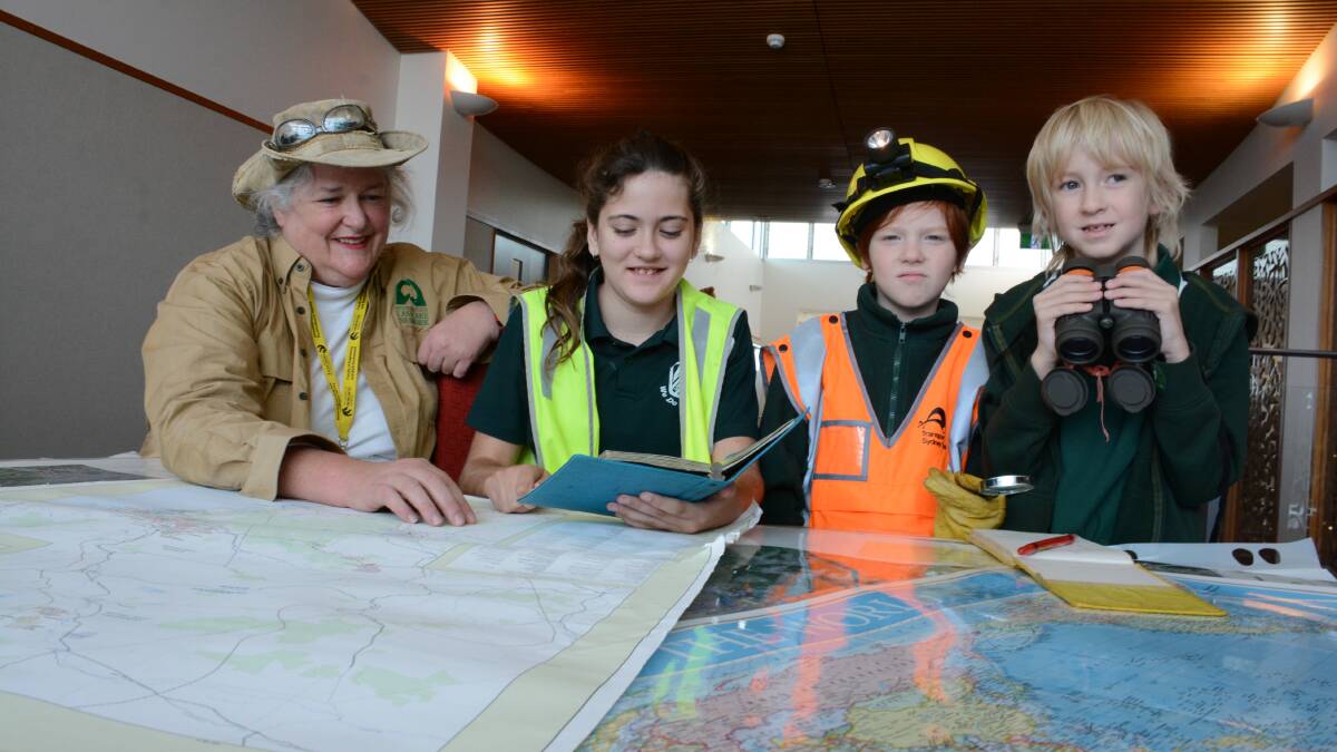 Archaeologist Sue Effonberger from the University of Newcastle's Tom Farrell Institute with Lansdowne Public School students, Tiara Hayes, Chris Morrison and Luke Williams.