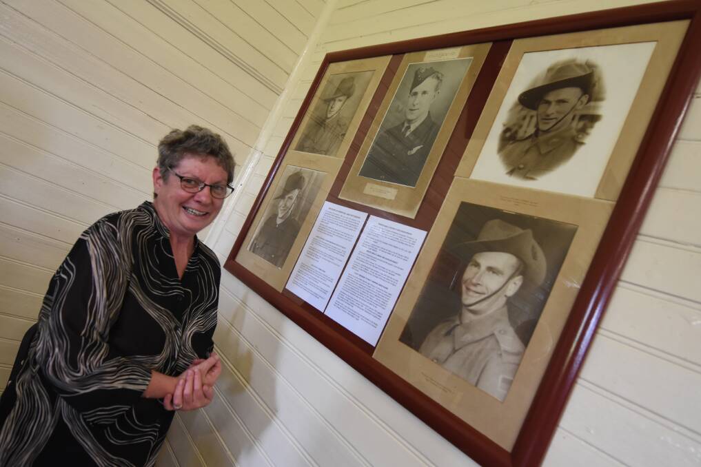 Margaret Oliver with photographs of the community soldiers who valiantly gave their lives have been restored and re-positioned in the Upper Lansdowne Hall. 