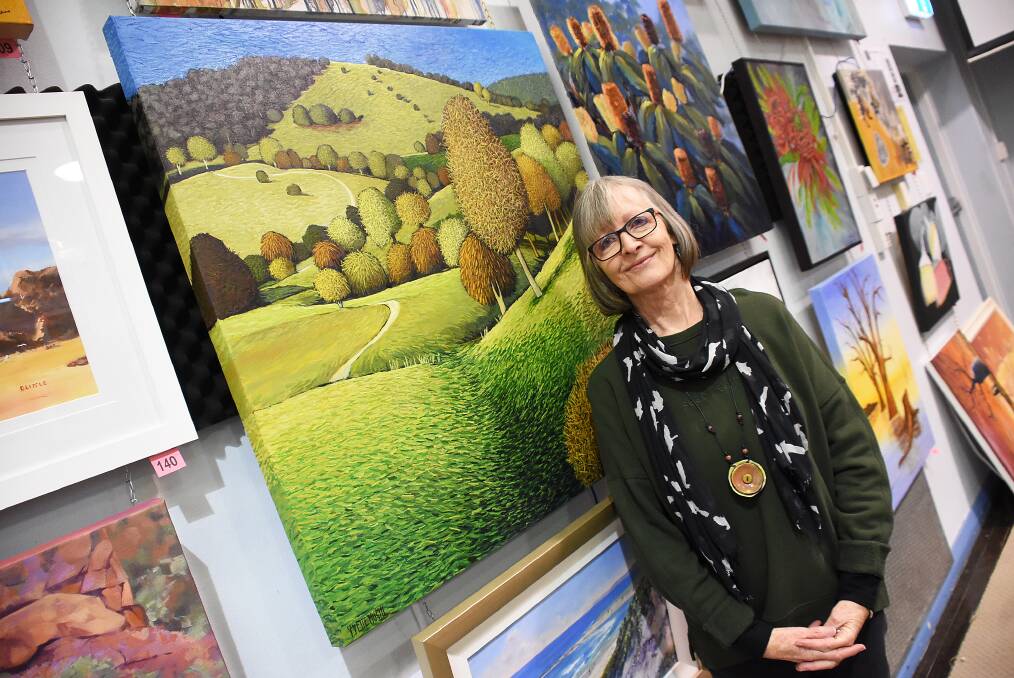 Manning artists, Yvette Hugill with her painting, Up Black Flat Lane, on exhibit at the Taree Open Art Exhibition.