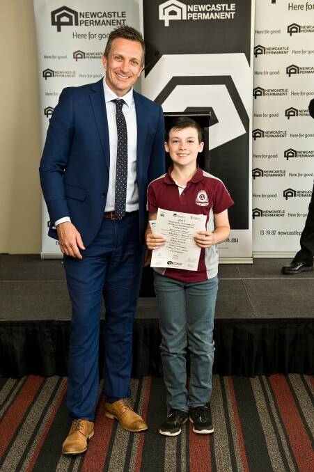 Taree West student Riley Brown is presented his award by Hunter Region Independent Schools chairperson, Darren Cox.