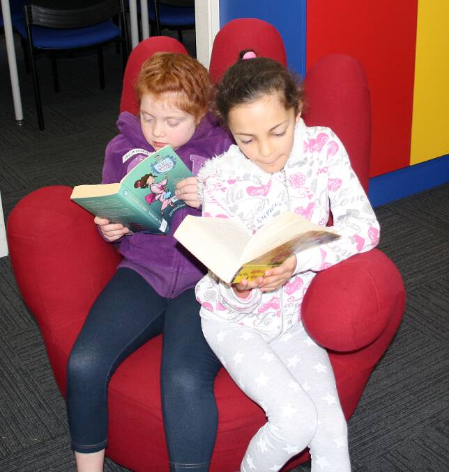 Alahna Dimmock and Stephanie Vassilo are immersed in their summer reading!