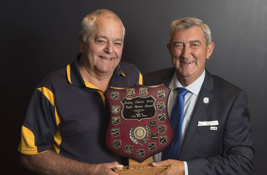 Youth director Murray Difford and president Ian Woollard display shield that the Rotary Club of Taree received for its youth activities during past year.