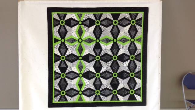 The raffle prize at the Harrington Quilt Show is a beautiful quilt, a Michelle Marvin design featuring a touch of green,