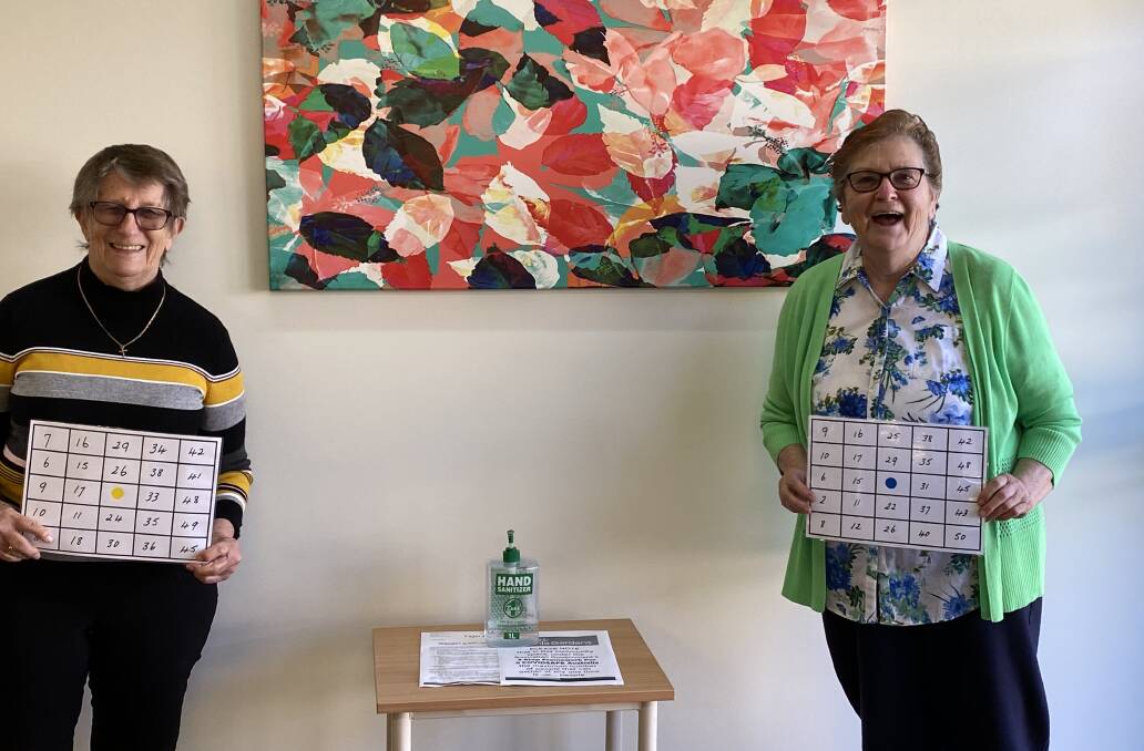 Dot Stuart (left) and Maddie Simmons (right) playing bingo
