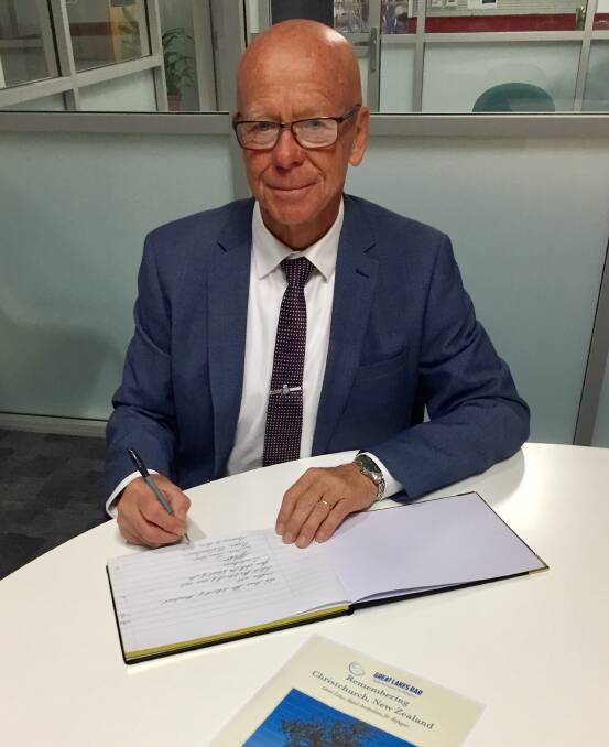MidCoast mayor, David West signs the condolence book which will be sent to the community of Christchurch, New Zealand.