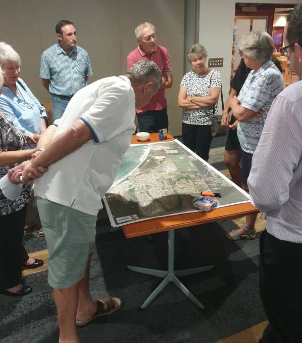 Residents examining the Pedestrian Access and Mobility Plan area map at the Old Bar information session.