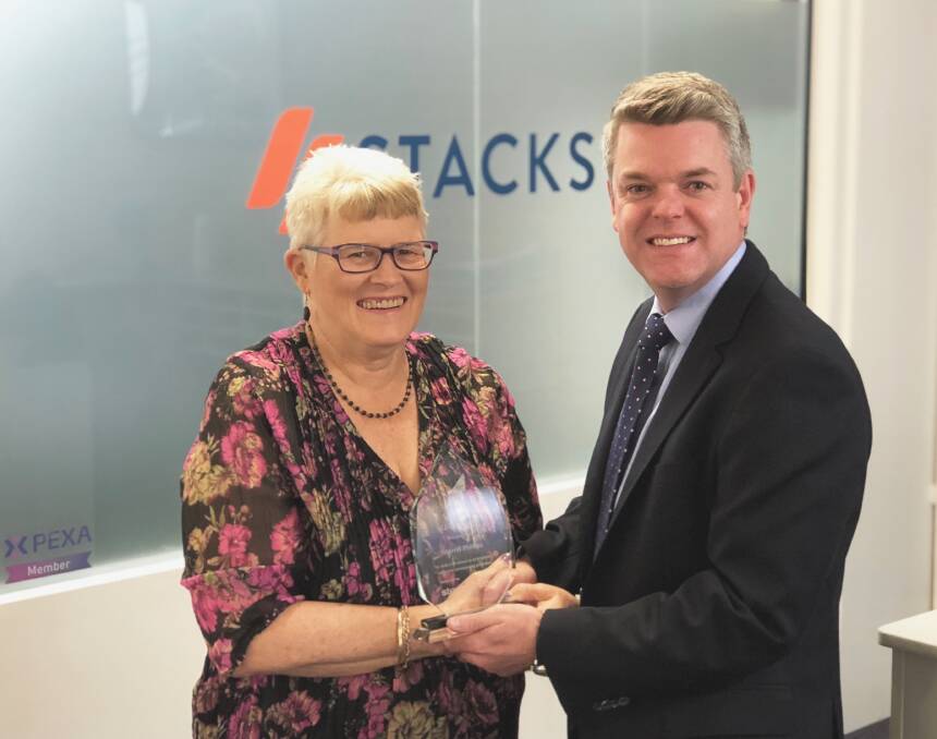 Dedicated to her work helping people buy and sell property: Conveyancer Merrill Phillips is congratulated by Stacks managing director Justin Stack.
