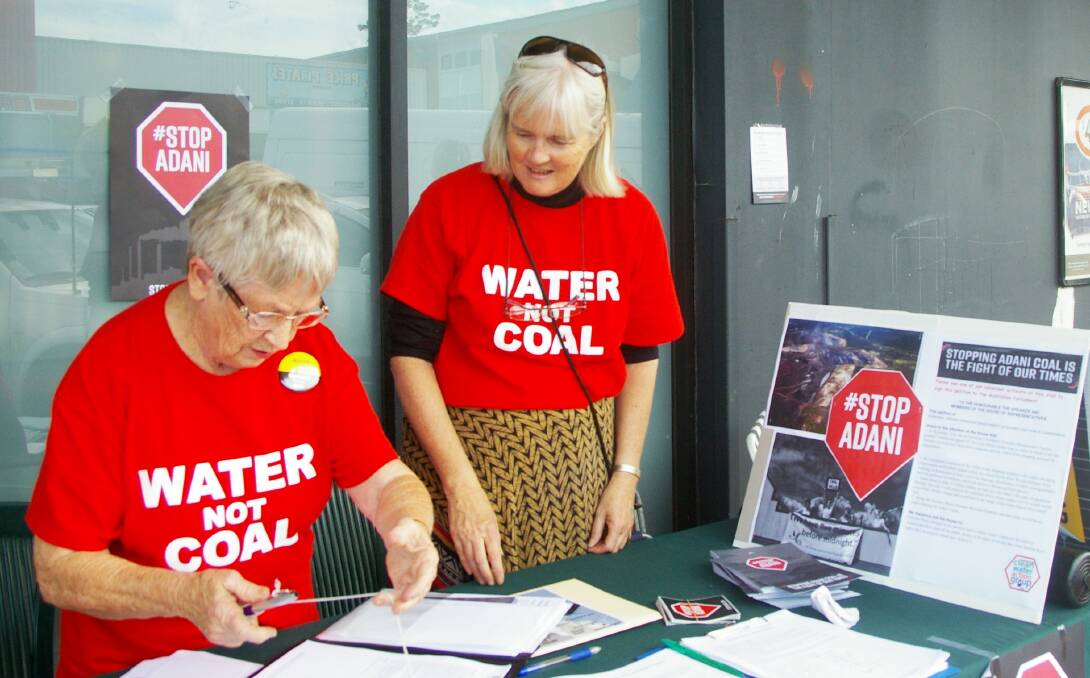 Taree stall: Prominent local Knitting Nanna, Margaret Tappert, signing the petition with Genevieve Godwin. Photo by Nawal Maharaj