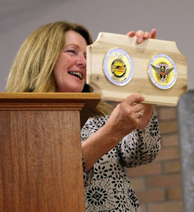 Old Bar Public School principal, Debbie Scanes, with the plaques presented to the school. 