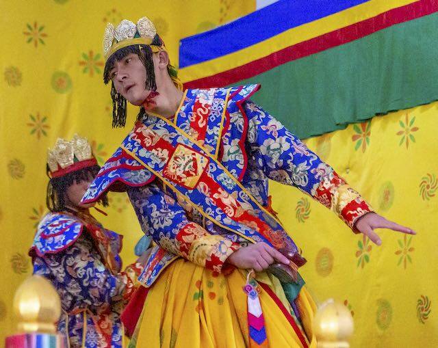 Bhutan dancers in national dress, which is worn most of the time. Bhutanese are very proud of their culture.