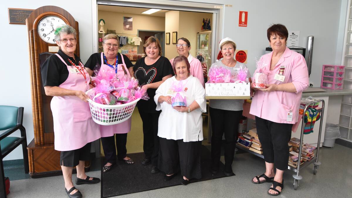 For the Pink Ladies: Carol Fletcher, Betty Grant, Toni Erickson, Jeanette Unicombe, Dianne Jenkins, Taree Woolworths store manager Michele Tidyman and Corinne Lang, president of the Manning Hospital Pink Ladies.