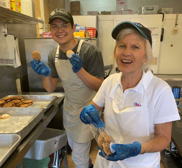 Omnicare Meals Service senior branch officer Terry Smith and cook Sergio Martinez baked biscuits to mark National Volunteer Week.