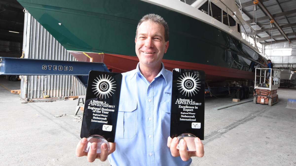 Steber International quality EHS manager Colin Steber with regional business awards received by Steber in 2017.