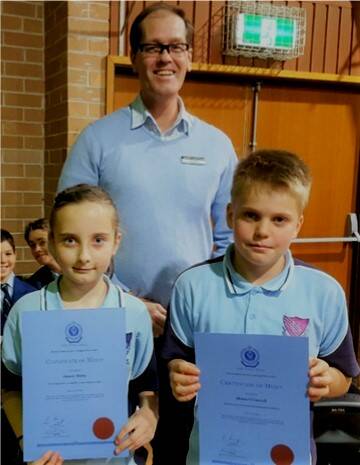 Teacher Rod Pye PBL awardees, year six student Bonnie Minns and year four student Henry OConnell.
