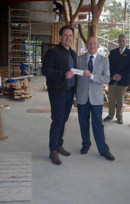 Freemasons president Wayne Broom presenting Jeremy Miller with the cheque for $20,000. Image supplied