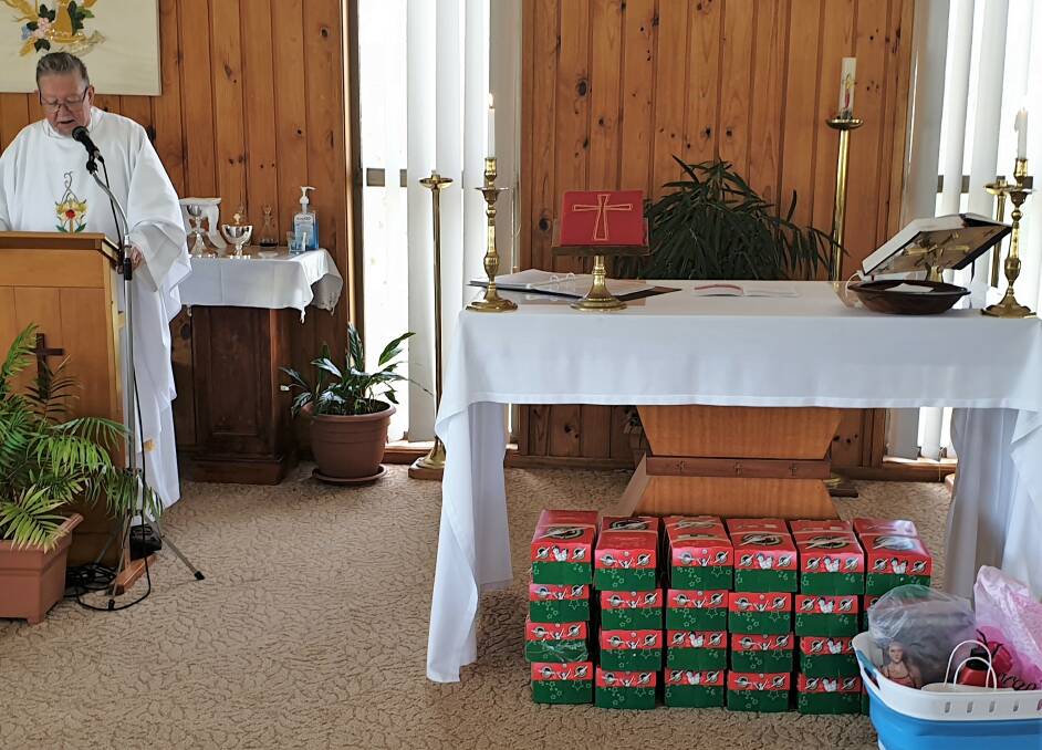 Shoe boxes of children's Christmas gifts after being blessed by Father Peter Tinney.
