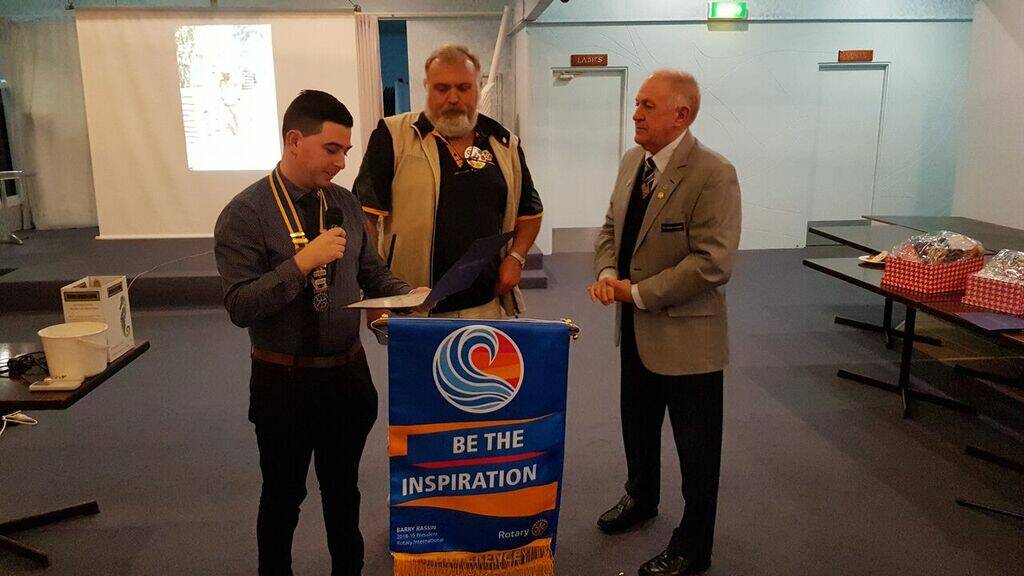 Taree North Rotary president Adam Scarff (left) and Past District Governor Ian Jackson (right) president Michael Byrne with his Paul Harrow Fellow.