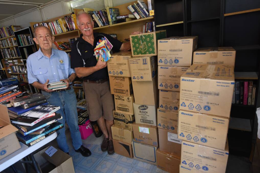 Taree North Rotary Club's Alf Childs and Bob Nelson at Taree Showground with boxes of books for the Donations in Kind project. Photo: Scott Calvin.