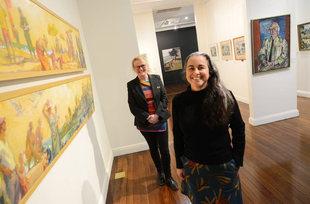 Manning Regional Art Gallery's Jane Hosking and Rachel Piercy stand by the work of Jocelyn Maughan, one of many currently on show as part of Women Artists from the Collection. Photo: Scott Calvin.