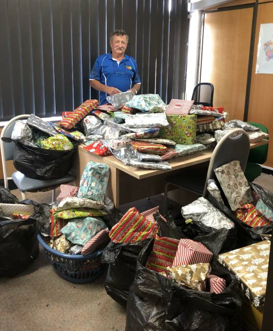 Seventy-year-old Larry Fulton buys, wraps and donates hundreds of children's presents every year.