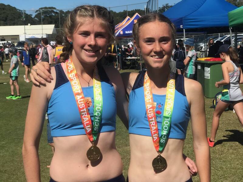 Sarah Schiffmann and Courtney Webeck celebrate their success together at the 2018 Australian Cross Country Championships on the Sunshine Coast. Photo supplied.