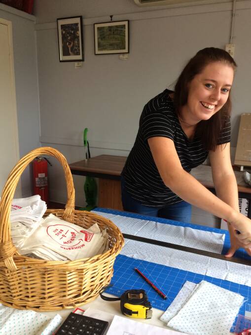 A cut out: A new resident to Gloucester, Emma Fraser has offered her helping hands to the project by cutting the material for the bags. Picture: Supplied