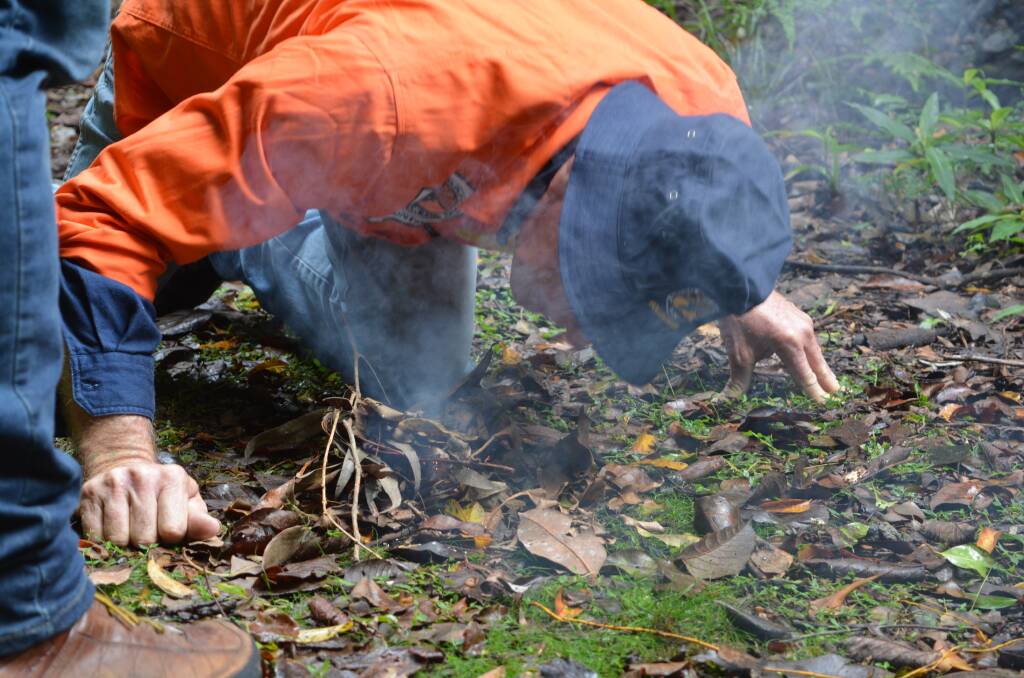 Glenn Jonas prepares a fire for a smoking ceremony to help ward off bad spirits at the end of the bush tucker tour. Photo Anne Keen